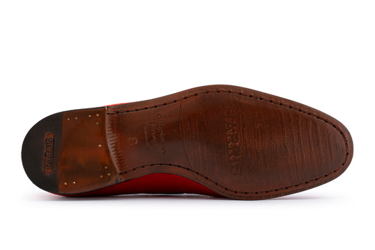 Moccasin en daim avec un pon rouge